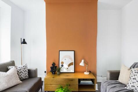 A stylish and inviting living room featuring mo...