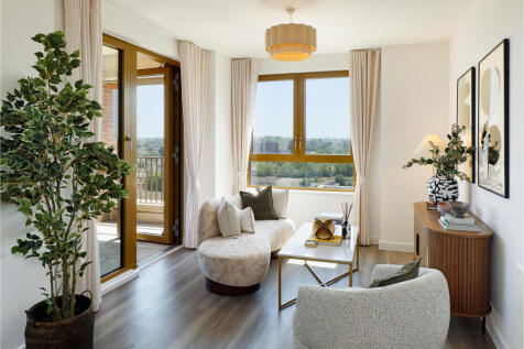 Living area photograph with door towards balcony and large window with views towards London