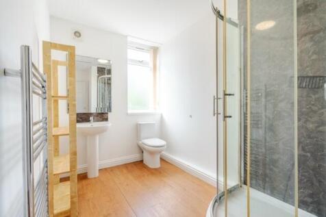 A clean and well-lit bathroom featuring a spaci...