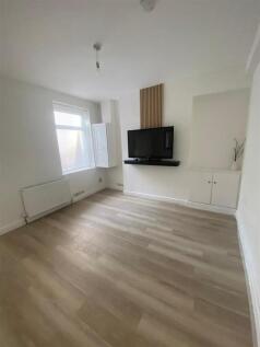 Bright modern lounge with wall-mounted TV...