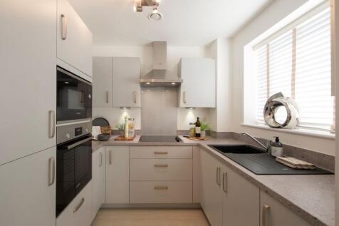 a kitchen with white cabinets