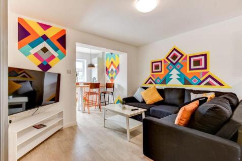 Bright, contemporary living room with a large s...
