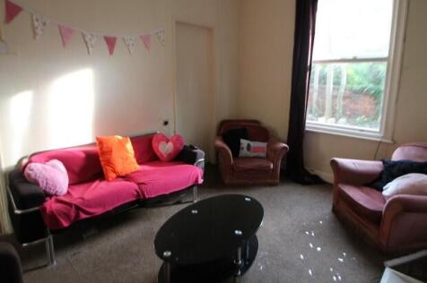 A bright and welcoming living room featuring co...