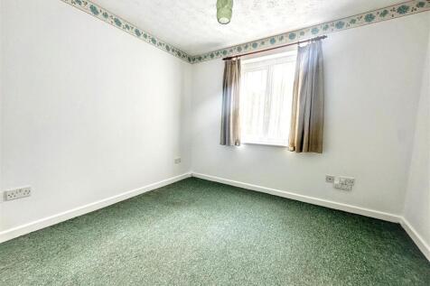 Bright and airy bedroom with large window...