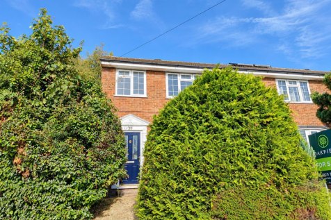 Brick House Framed by Lush Hedges.png