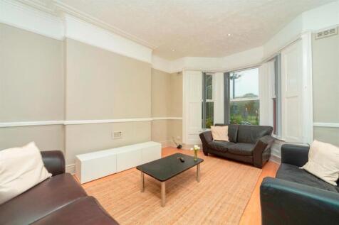 Bright living room with bay window and sofas...