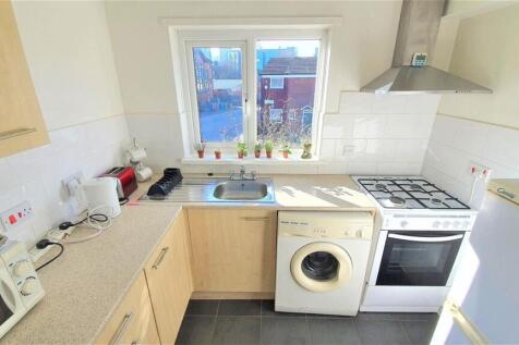 Bright kitchen with modern appliances and windo...