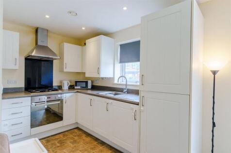 Bright modern kitchen with integrated appliance...
