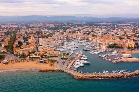 Aerial cityscape of France city Frejus with yachts