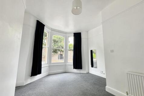 Bright bedroom with large classic bay window...