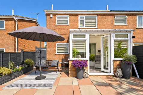 Sunny Brick Patio with Purple Flowers.png