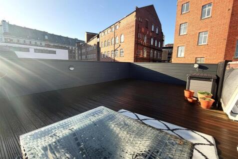 Spacious sun-drenched roof terrace with decking...