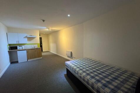 A spacious living room with a comfortable bed a...