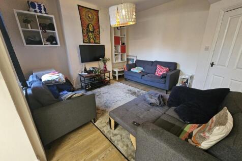 Bright, well-furnished living room with multipl...
