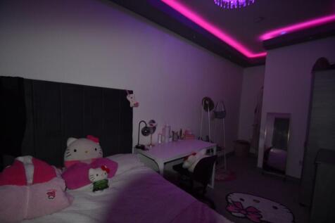 Cozy bedroom with a comfortable bed, playful de...