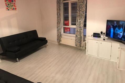 Bright, modern living room with seating and TV...