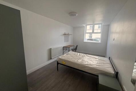 Spacious double bedroom featuring a comfortable...