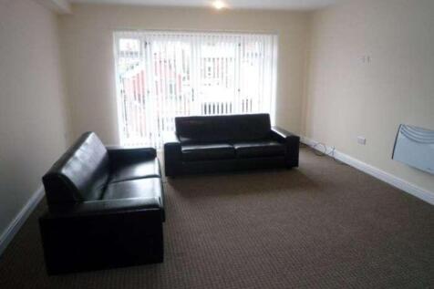 Bright, neutrally decorated living room with la...