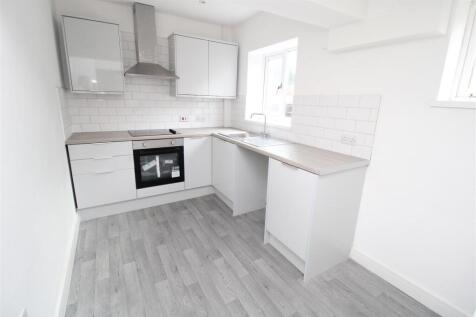 Bright modern kitchen with sleek white cabinets...