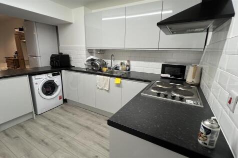 Modern kitchen with sleek white cabinetry...