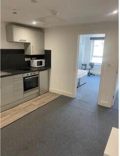 A modern kitchenette with ample space for cooki...