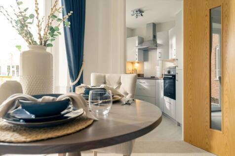 a dining room table with a vase and a bowl on it