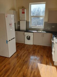 Bright kitchen with modern appliances and wood ...