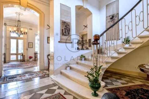Elegant interior with a curved staircase, carpeted