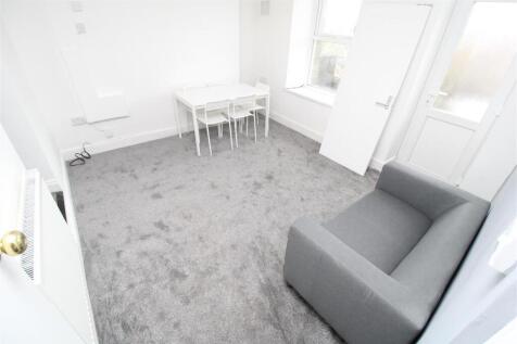 Bright lounge with plush carpet and dining spac...