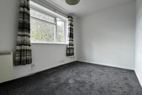 Bright and clean bedroom with a large window...