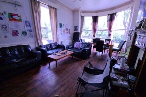 A welcoming living room featuring multiple larg...