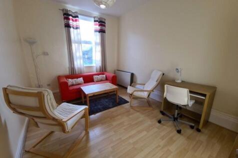 Bright, neatly furnished living room with light...