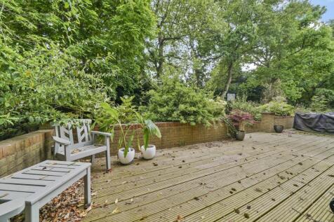 Spacious wooden decking with lush garden views...