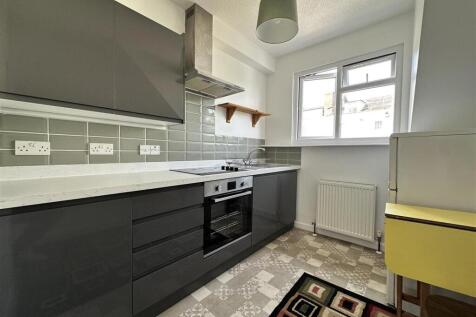 Modern kitchen with sleek cabinetry and natural...