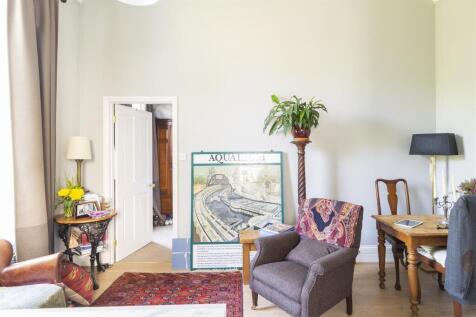 Bright lounge with high ceilings and study desk...