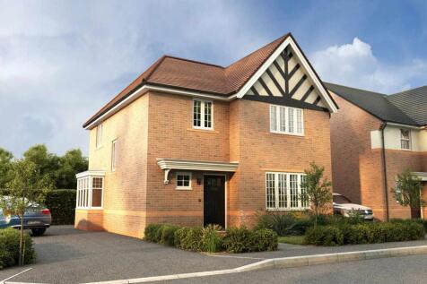 A two-story brick house with a distinctive Tudor-style facade