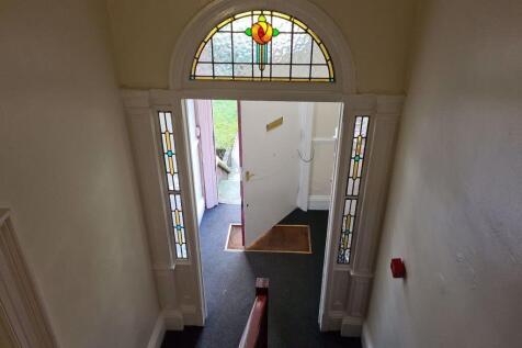Bright entrance hallway with decorative stained...