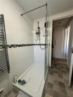 Modern tiled shower with sleek glass enclosure...