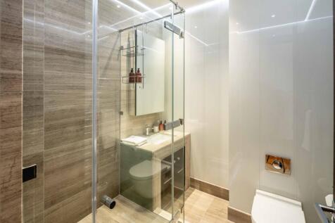 Contemporary bathroom with a glass-enclosed sho...