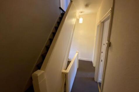 Well-maintained entrance corridor with a stairc...