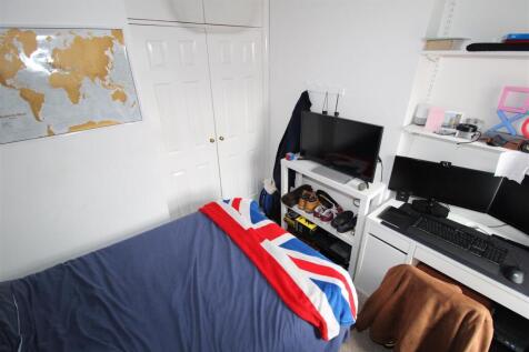 Bright bedroom with workspace and ample storage...