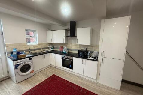 Modern kitchen with white units and appliances...