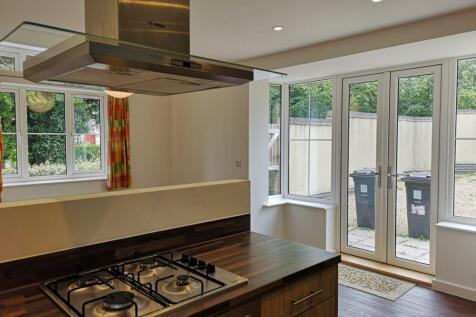 A spacious and modern kitchen with ample natura...