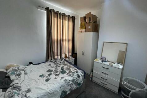 Bright furnished bedroom with a double bed, war...