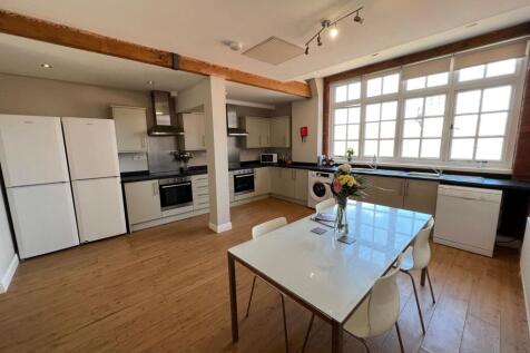 Bright, modern open-plan kitchen with large mul...