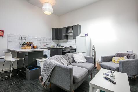 Bright, modern open-plan living area with a com...