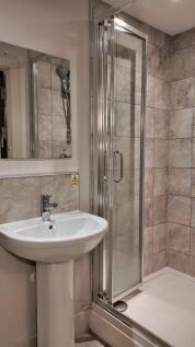 Neat modern bathroom with a tiled walk-in showe...