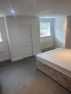 A spacious and bright double bedroom featuring ...