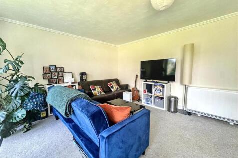 Bright, cosy living room with plush seating...