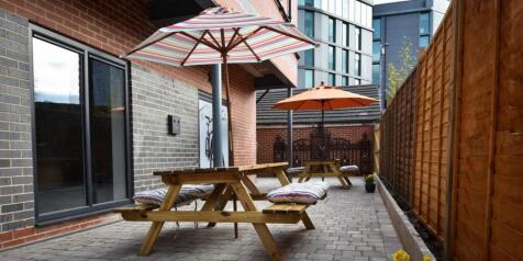 Charming paved patio with social seating areas...